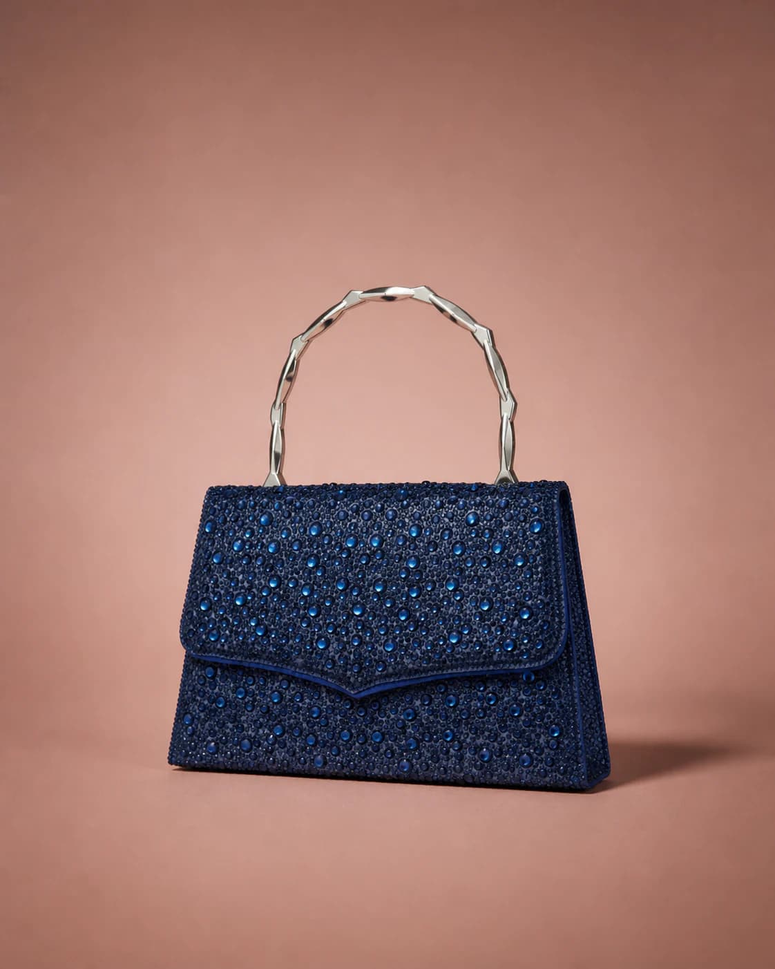 Ashley navy crystal evening bag on a dusty rose studio backdrop