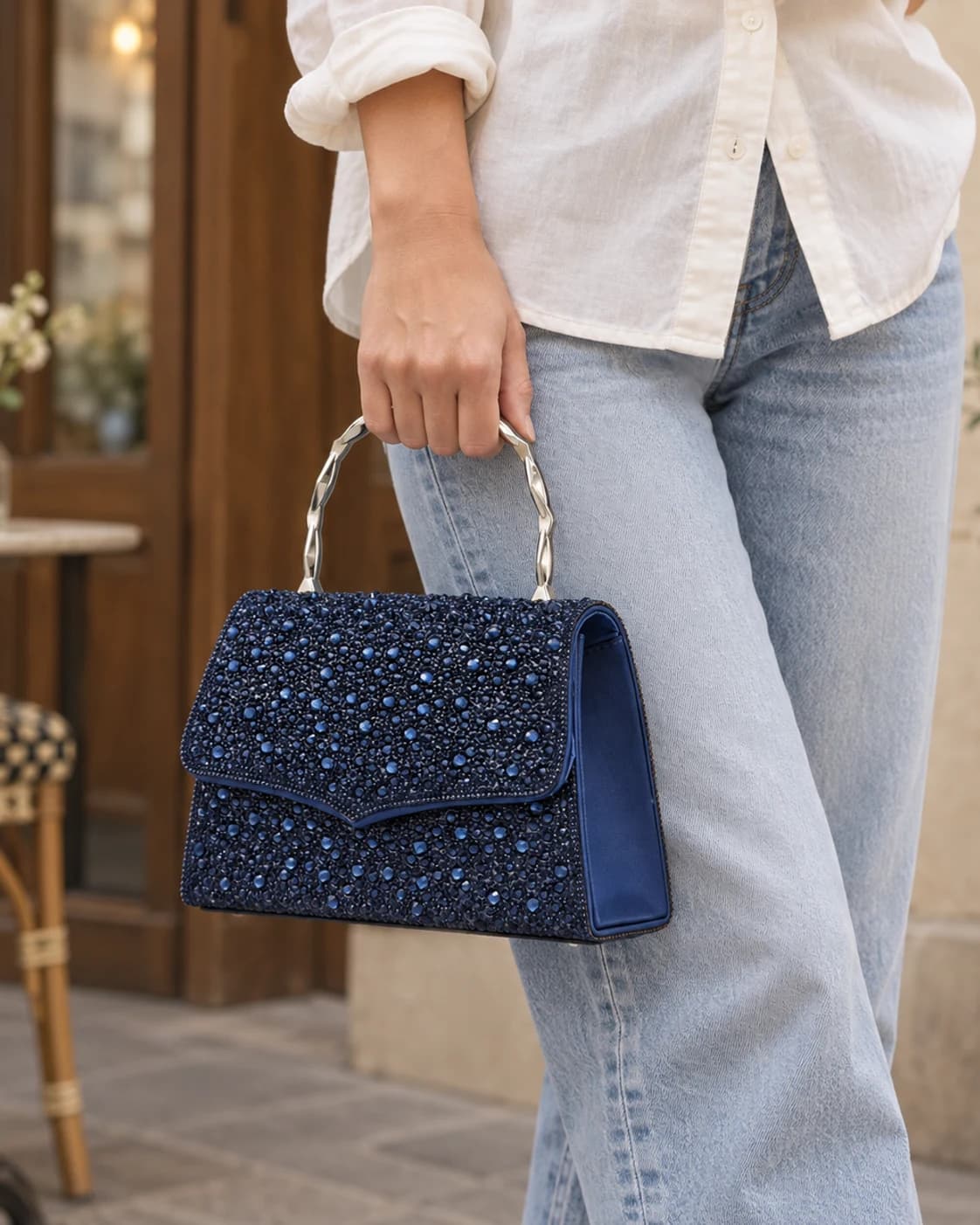 Ashley navy crystal evening bag styled outside a café
